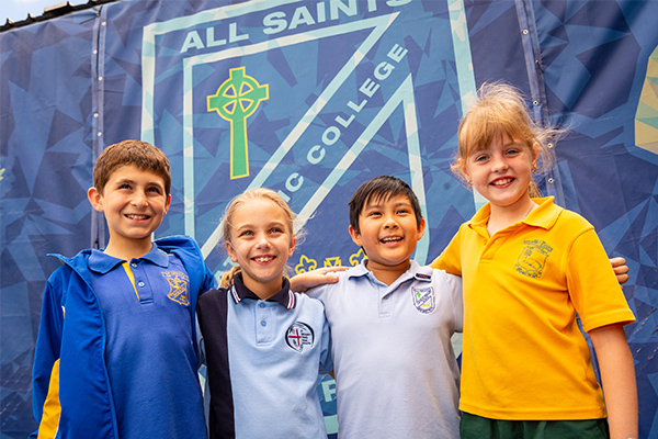 All Saints Catholic College News and Events students in front of school emblem